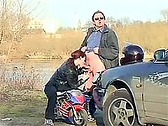 Dirty senior abuses a cute teenager biker chick outdoor;